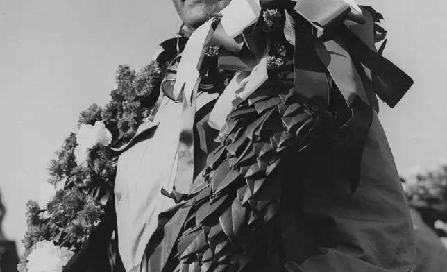FILE - Italy's Giuseppe Farina, winner of the 11th Grand Prix D'Europe poses for a photo, at Silverstone, England, Jan. 13, 1950. (AP Photo/Leslie Priest, File)