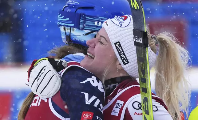 United States' Mikaela Shiffrin, left, third placed, embraces Austria's Katharina Truppe, the winner, after completing an alpine ski, women's World Cup slalom in Are, Sweden, Sunday, March 9, 2025. (AP Photo/Giovanni Auletta)