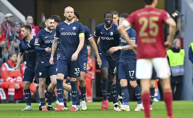 Bochum's players celebrate their goal during the German Bundesliga soccer match between Bayern Munich and VfL Bochum at the Allianz Arena in Munich, Germany, Saturday, March 8, 2025. (Sven Hoppe/dpa via AP)