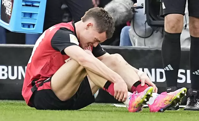 Leverkusen's Florian Wirtz gets injured and has to leave the pitch during the Bundesliga soccer match between Bayer Leverkusen and Werder Bremen at the BayArena in Leverkusen, Germany, Saturday, March 8, 2025. (AP Photo/Martin Meissner)