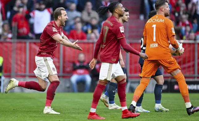 Bayern's Harry Kane, left, gestures, during the German Bundesliga soccer match between Bayern Munich and VfL Bochum at the Allianz Arena in Munich, Germany, Saturday, March 8, 2025. (Sven Hoppe/dpa via AP)