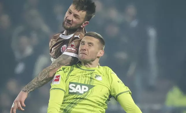 St. Pauli's Siebe Van der Heyden and Hoffenheim's Pavel Kaderabek, front, in action during the Bundesliga soccer match between FC St. Pauli - TSG 1899 Hoffenheim, Millerntor Stadium, Hamburg, Germany, Friday March 14, 2025. (Christian Charisius/dpa via AP)