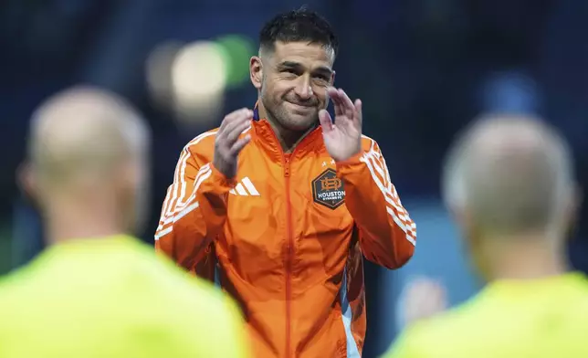 Houston Dynamo midfielder Nicolás Lodeiro acknowledges the crowd as he is honored by the Seattle Sounders for his contribution to the club before an MLS soccer match Saturday, March 22, 2025, in Seattle. (AP Photo/Lindsey Wasson)