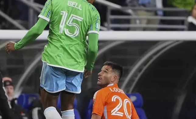Seattle Sounders defender Jon Bell (15) heads the ball as Houston Dynamo midfielder Nicolás Lodeiro (20) looks on during the first half of an MLS soccer match Saturday, March 22, 2025, in Seattle. (AP Photo/Lindsey Wasson)