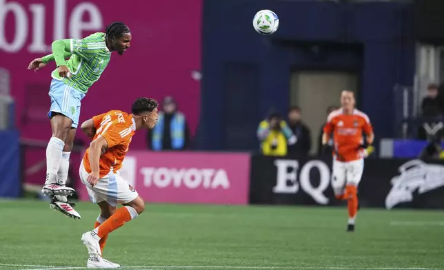 Seattle Sounders defender Jon Bell heads the ball against Houston Dynamo forward Ezequiel Ponce, right, during the first half of an MLS soccer match Saturday, March 22, 2025, in Seattle. (AP Photo/Lindsey Wasson)