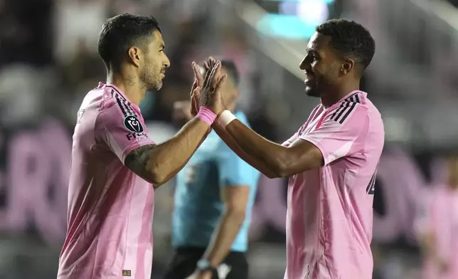 Inter Miami forward Luis Suárez, left, is congratulated by midfielder Yannick Bright (42) after scoring a goal during the second half of a CONCACAF Champions Cup soccer match against Cavalier Thursday, March 6, 2025, in Fort Lauderdale, Fla. (AP Photo/Lynne Sladky)