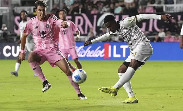 Cavalier midfielder Christopher Ainsworth (11) kicks the ball as Inter Miami midfielder Federico Redondo, left, defends during the first half of a CONCACAF Champions Cup soccer match Thursday, March 6, 2025, in Fort Lauderdale, Fla. (AP Photo/Lynne Sladky)