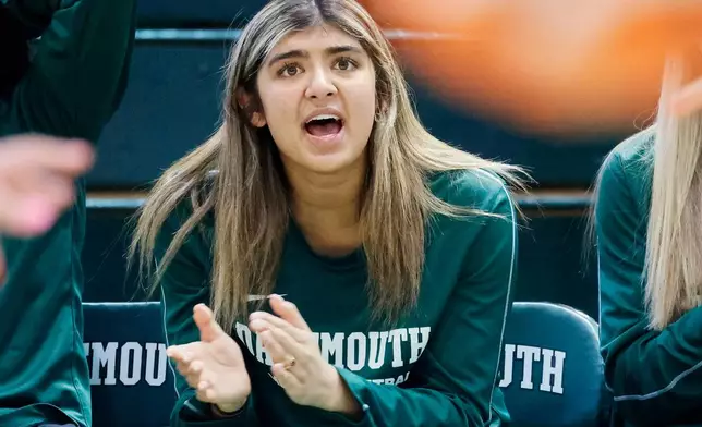 Dartmouth's Annika Jiwani, one of six women from Kobe Bryant’s Mamba Academy going through their first experience with college basketball, cheers her team from the bench during an NCAA college basketball game against Princeton, Saturday, March 1, 2025, in Hanover, N.H. (AP Photo/Mary Schwalm)