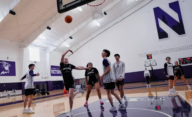Northwestern freshman Kat Righeimer, second from left, one of six women from Kobe Bryant’s Mamba Academy going through their first experience with college basketball, works with teammates during NCAA college basketball practice in Evanston, Ill., Tuesday, Feb. 25, 2025. (AP Photo/Nam Y. Huh)