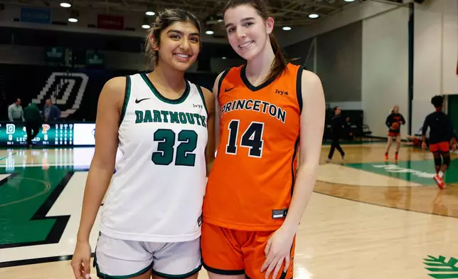Dartmouth's Annika Jiwani, left, and Princeton's Emily Eadie, two of six women from Kobe Bryant’s Mamba Academy going through their first experience with college basketball, pose before an NCAA college basketball game, Saturday, March 1, 2025, in Hanover, N.H. (AP Photo/Mary Schwalm)
