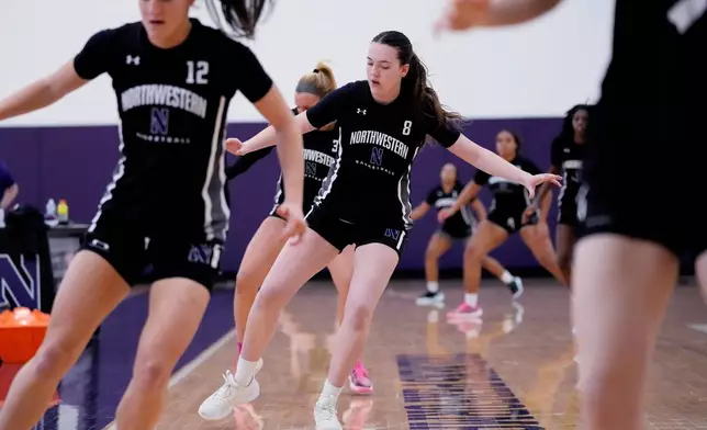 Northwestern freshman Kat Righeimer, center, one of six women from Kobe Bryant’s Mamba Academy going through their first experience with college basketball, warms up with teammates during NCAA college basketball practice in Evanston, Ill., Tuesday, Feb. 25, 2025. (AP Photo/Nam Y. Huh)