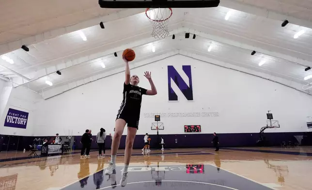 Northwestern freshman Kat Righeimer, one of six women from Kobe Bryant’s Mamba Academy going through their first experience with college basketball, drives to the basket during NCAA college basketball practice in Evanston, Ill., Tuesday, Feb. 25, 2025. (AP Photo/Nam Y. Huh)