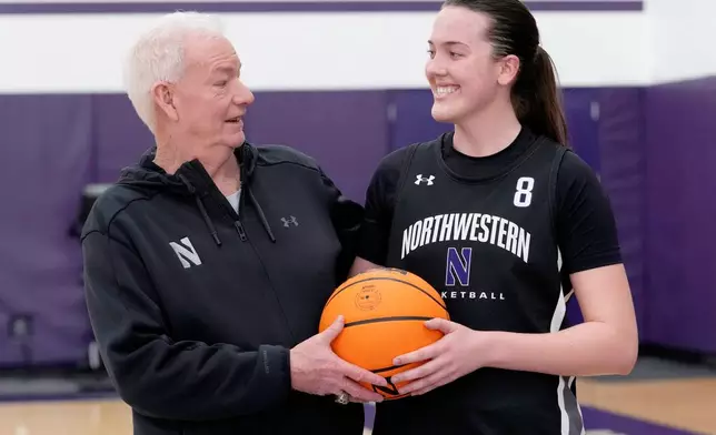 Northwestern women's basketball head coach Joe McKeown, left, talks with freshman Kat Righeimer, one of six women from Kobe Bryant’s Mamba Academy going through their first experience with college basketball, during NCAA college basketball practice in Evanston, Ill., Tuesday, Feb. 25, 2025. (AP Photo/Nam Y. Huh)