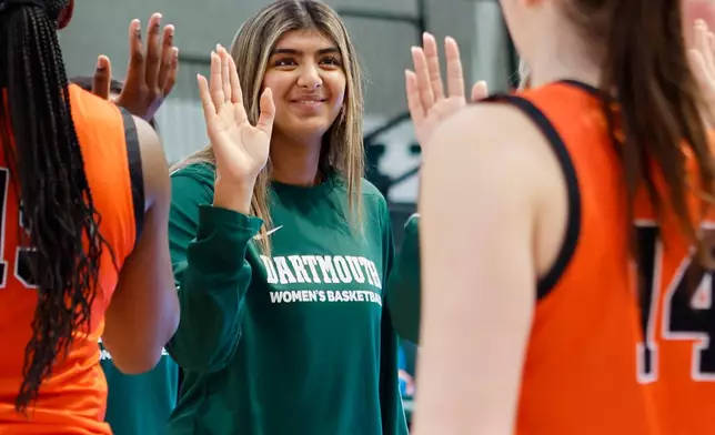 Dartmouth's Annika Jiwani, one of six women from Kobe Bryant’s Mamba Academy going through their first experience with college basketball, smiles as she acknowledges Princeton's Emily Eadie (14) at the end of an NCAA college basketball game, Saturday, March 1, 2025, in Hanover, N.H. (AP Photo/Mary Schwalm)