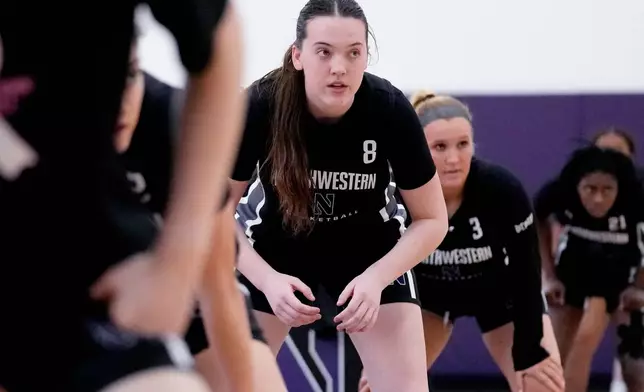 Northwestern freshman Kat Righeimer, one of six women from Kobe Bryant’s Mamba Academy going through their first experience with college basketball, warms up with teammates during NCAA college basketball practice in Evanston, Ill., Tuesday, Feb. 25, 2025. (AP Photo/Nam Y. Huh)