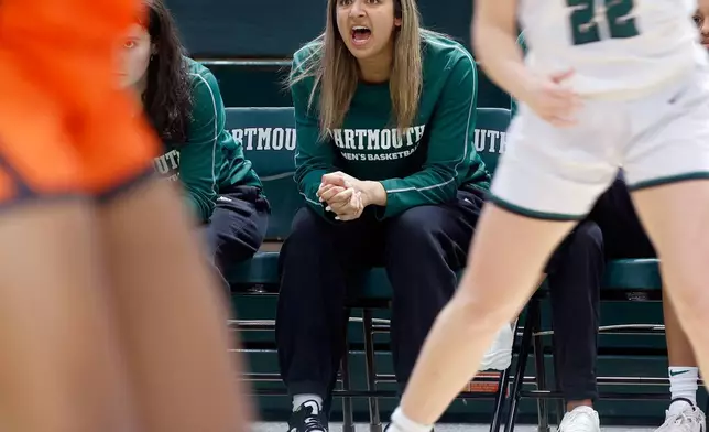 Dartmouth's Annika Jiwani, one of six women from Kobe Bryant’s Mamba Academy going through their first experience with college basketball, cheers her team from the bench during an NCAA college basketball game against Princeton, Saturday, March 1, 2025, in Hanover, N.H. (AP Photo/Mary Schwalm)