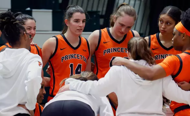 Princeton's Emily Eadie (14), one of six women from Kobe Bryant’s Mamba Academy going through their first experience with college basketball, looks on from a team huddle during the second half of an NCAA college basketball game against Dartmouth, Saturday, March 1, 2025, in Hanover, N.H. (AP Photo/Mary Schwalm)
