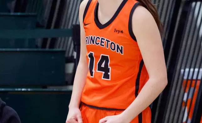 Princeton's Emily Eadie, one of six women from Kobe Bryant’s Mamba Academy going through their first experience with college basketball, cheers her team from the bench during the second half of an NCAA college basketball game against Dartmouth, Saturday, March 1, 2025, in Hanover, N.H. (AP Photo/Mary Schwalm)