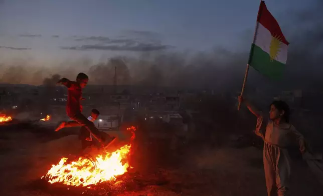 Syrian Kurds celebrate their Nowruz, Kurdish New Year in Amuda, Hasaka region, northeastern Syria, Thursday March 20, 2025. (AP Photo/Baderkhan Ahmad)