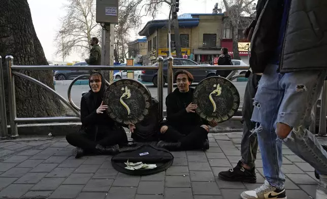 Street musicians play the Daf, a hand-held Persian drum, ahead of Iranian New Year, or Nowruz, at Tajrish Sq. in northern Tehran, Iran, Saturday, March 15, 2025. The Persian new year, or Nowruz, which means "New Day", is the most important holiday for Iranians, it marks the beginning of the spring on vernal equinox. (AP Photo/Vahid Salemi)