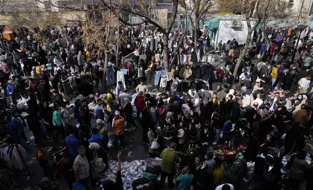 People shop for the Persian new year, or Nowruz, the most important holiday for Iranians which marks the beginning of the spring, in the old main bazaar of Tehran, Iran, Tuesday, March 18, 2025. (AP Photo/Vahid Salemi)