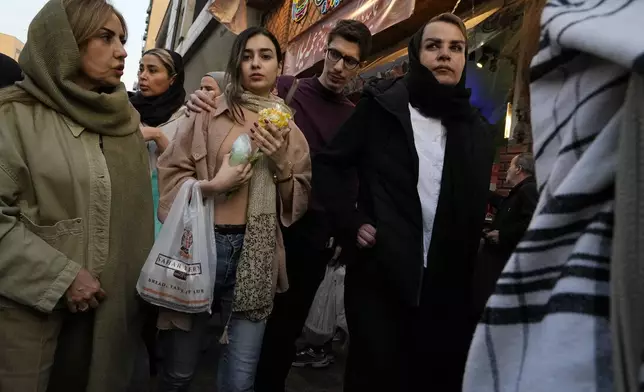 People shop at Tajrish traditional bazaar ahead of Iranian New Year, or Nowruz in northern Tehran, Iran, Saturday, March 15, 2025. The Persian new year, or Nowruz, which means "New Day", is the most important holiday for Iranians, it marks the beginning of the spring on vernal equinox. (AP Photo/Vahid Salemi)