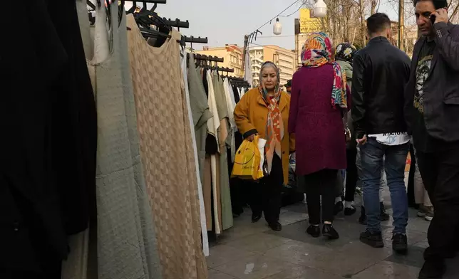 People shop ahead of Iranian New Year, or Nowruz at Tajrish Sq. in northern Tehran, Iran, Saturday, March 15, 2025. The Persian new year, or Nowruz, which means "New Day", is the most important holiday for Iranians, it marks the beginning of the spring on vernal equinox. (AP Photo/Vahid Salemi)