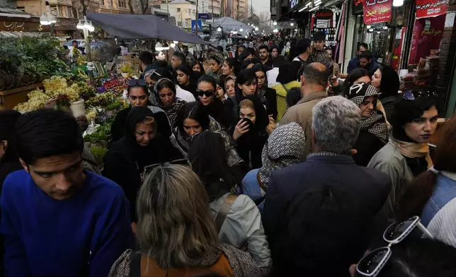 People shop at Tajrish traditional bazaar ahead of Iranian New Year, or Nowruz in northern Tehran, Iran, Saturday, March 15, 2025. The Persian new year, or Nowruz, which means "New Day", is the most important holiday for Iranians, it marks the beginning of the spring on vernal equinox. (AP Photo/Vahid Salemi)