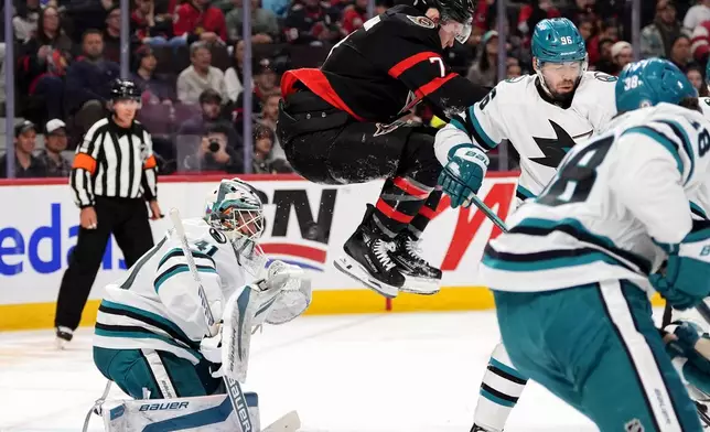 Ottawa Senators' Brady Tkachuk (7) leaps in front of San Jose Sharks goaltender Vitek Vanecek (41) during second period NHL hockey action in Ottawa, on Saturday, March 1, 2025. (Justin Tang/The Canadian Press via AP)