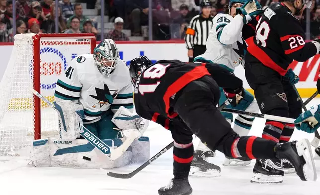 San Jose Sharks goaltender Vitek Vanecek (41) makes a save on Ottawa Senators' Tim Stutzle (18) during second period NHL hockey action in Ottawa, on Saturday, March 1, 2025. (Justin Tang/The Canadian Press via AP)