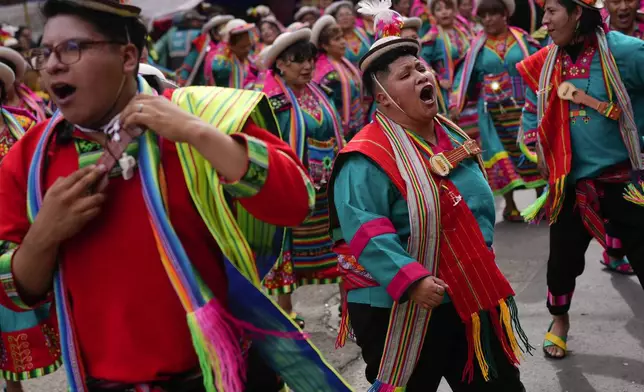 Revelers dance during the "Jisk'a Anata," or small party in Aymara, in La Paz, Bolivia, Monday, March 3, 2025. (AP Photo/Juan Karita)