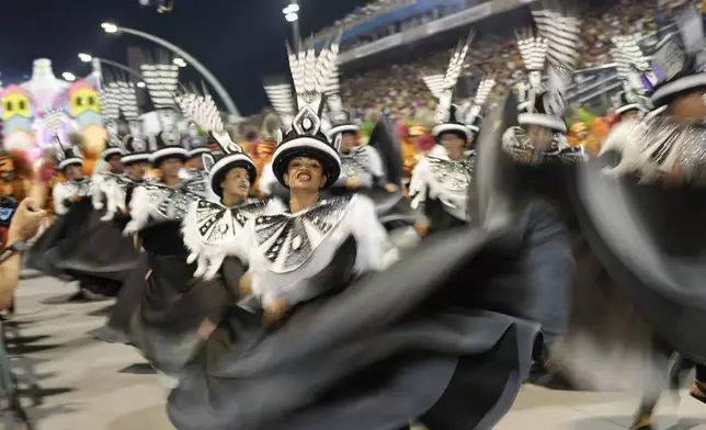 Dancers from the Colorado do Bras samba school perform during a carnival parade in Sao Paulo, Friday, Feb. 28, 2025. (AP Photo/Andre Penner)