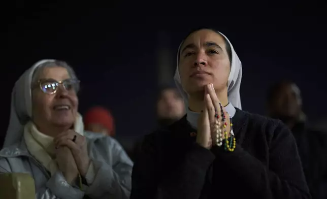 Catholic nuns listen to a recorded message from Pope Francis during a prayer of the Rosary for Pope Francis in St. Peter's Square at The Vatican, Thursday, March 6, 2025. (AP Photo/Francisco Seco)