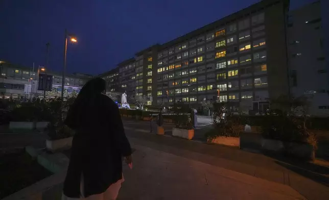 A nun prays for Pope Francis in front of the Agostino Gemelli Polyclinic, in Rome, Friday, March 7, 2025, where the Pontiff is hospitalized since Friday, Feb. 14. (AP Photo/Andrew Medichini)