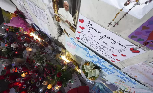 Candles for Pope Francis are seen in front of the Agostino Gemelli Polyclinic, in Rome, Friday, March 7, 2025, where the Pontiff is hospitalized since Friday, Feb. 14. (AP Photo/Andrew Medichini)