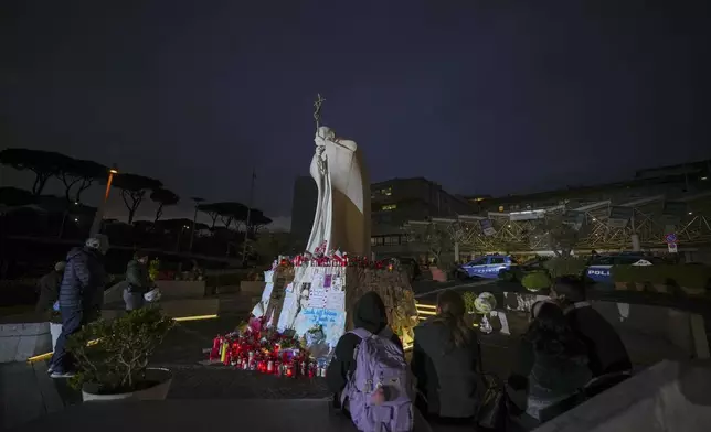 People pray for Pope Francis in front of the Agostino Gemelli Polyclinic, in Rome, Friday, March 7, 2025, where the Pontiff is hospitalized since Friday, Feb. 14. (AP Photo/Andrew Medichini)