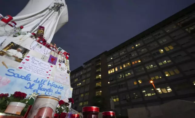 Candles for Pope Francis are seen in front of the Agostino Gemelli Polyclinic, in Rome, Friday, March 7, 2025, where the Pontiff is hospitalized since Friday, Feb. 14. (AP Photo/Andrew Medichini)