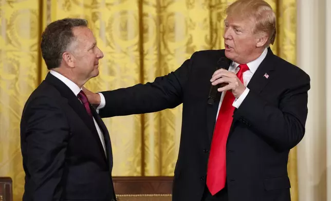 FILE - President Donald Trump speaks to businessman Steve Witkoff, who lost his son Andrew to a prescription drug overdose, during the White House Opioid Summit in the East Room of the White House, March 1, 2018, in Washington. (AP Photo/Evan Vucci, File)