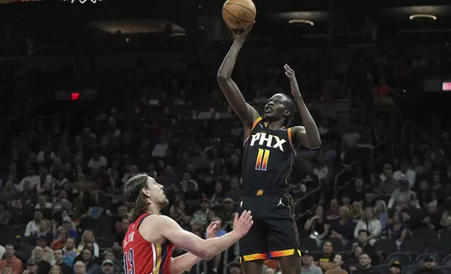 Phoenix Suns center Bol Bol (11) shoots over New Orleans Pelicans forward Kelly Olynyk during the first half of an NBA basketball game, Friday, Feb. 28, 2025, in Phoenix. (AP Photo/Rick Scuteri)
