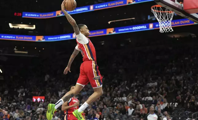 New Orleans Pelicans guard Jordan Hawkins (24) dunks against the Phoenix Suns during the second half of an NBA basketball game, Friday, Feb. 28, 2025, in Phoenix. (AP Photo/Rick Scuteri)