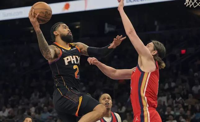 Phoenix Suns center Nick Richards (2) drives against New Orleans Pelicans forward Kelly Olynyk, right, during the first half of an NBA basketball game, Friday, Feb. 28, 2025, in Phoenix. (AP Photo/Rick Scuteri)