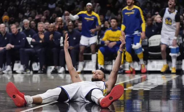 Golden State Warriors' Stephen Curry (30) celebrates after scoring during the second half of an NBA basketball game against the Brooklyn Nets Thursday, March 6, 2025, in New York. (AP Photo/Frank Franklin II)
