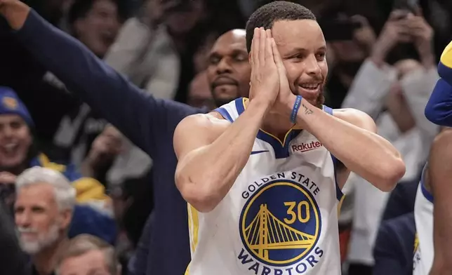 Golden State Warriors' Stephen Curry (30) gestures after making a three-point shot during the second half of an NBA basketball game against the Brooklyn Nets Thursday, March 6, 2025, in New York. (AP Photo/Frank Franklin II)