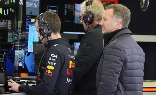 Red Bull team principal Christian Horner, right, stands in the pit lane during a Formula One pre-season test at the Bahrain International Circuit in Sakhir, Bahrain, Thursday, Feb. 27, 2025. (AP Photo/Darko Bandic)