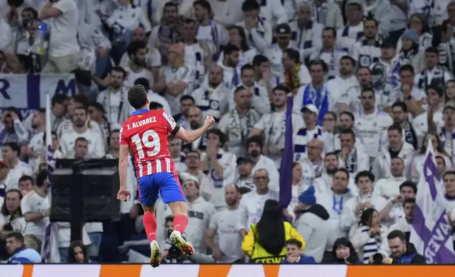 Atletico Madrid's Julian Alvarez celebrates after scoring his side's opening goal during the Champions League round of 16 first leg soccer match between Real Madrid and Atletico Madrid at the Bernebeu stadium in Madrid, Spain, Tuesday, March 4, 2025. (AP Photo/Manu Fernandez)