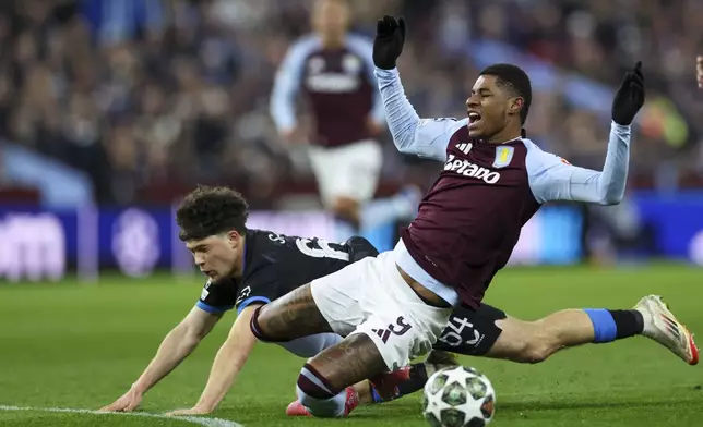 Aston Villa's Marcus Rashford, front, duels for the ball with Brugge's Kyriani Sabbe during the Champions League round of 16 second leg soccer match between Aston Villa and Club Brugge at the Villa Park stadium in Birmingham, England, Wednesday, March 12, 2025. (AP Photo/Darren Staples)