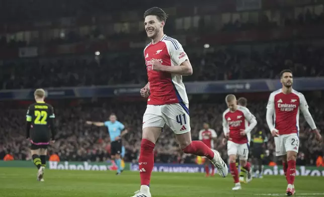 Arsenal's Declan Rice celebrates after scoring his side's second goal during the Champions League round of 16 second leg soccer match between Arsenal FC and PSV Eindhoven at the Arsenal stadium in London, England, Wednesday, March 12, 2025. (AP Photo/Alastair Grant)