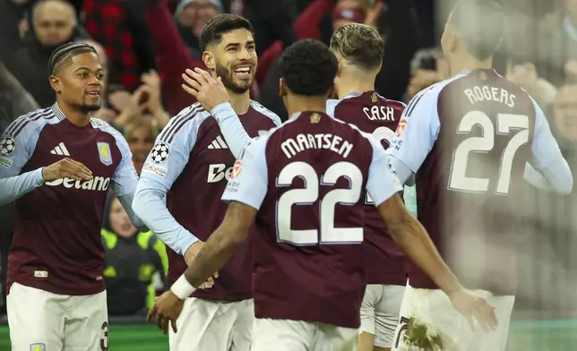 Aston Villa's Marco Asensio, second left, celebrates with teammates after scoring opening goal during the Champions League round of 16 second leg soccer match between Aston Villa and Club Brugge at the Villa Park stadium in Birmingham, England, Wednesday, March 12, 2025. (AP Photo/Darren Staples)