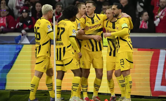 Dortmund players celebrate after a goal during the Champions League round of 16 second leg soccer match between Lille and Borussia Dortmund in Villeneuve-d'Ascq , Wednesday, March 12, 2025. (AP Photo/Michel Euler)