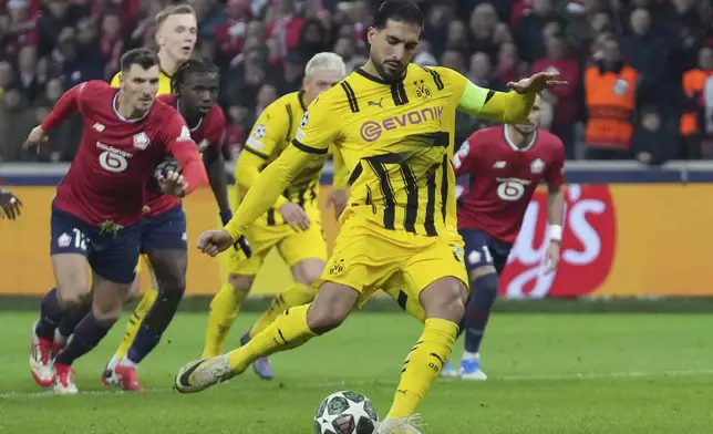 Dortmund's Emre Can scores from a penalty kick during the Champions League round of 16 second leg soccer match between Lille and Borussia Dortmund in Villeneuve-d'Ascq , Wednesday, March 12, 2025. (AP Photo/Michel Euler)